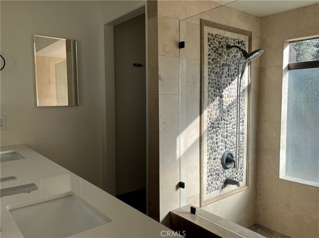 bathroom featuring sink and tiled shower