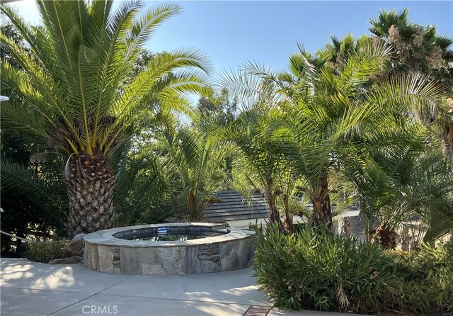 surrounding community featuring a jacuzzi