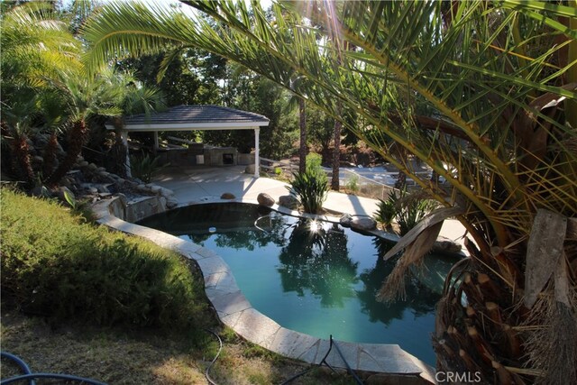 view of swimming pool featuring a gazebo and a patio