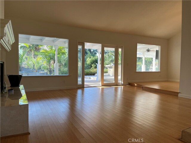 unfurnished living room featuring light hardwood / wood-style floors and ceiling fan