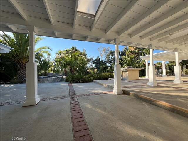 view of patio with an in ground hot tub