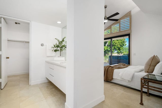 tiled bedroom with access to outside, a closet, a walk in closet, vaulted ceiling, and ceiling fan