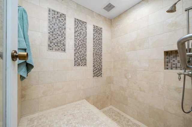 bathroom with tiled shower