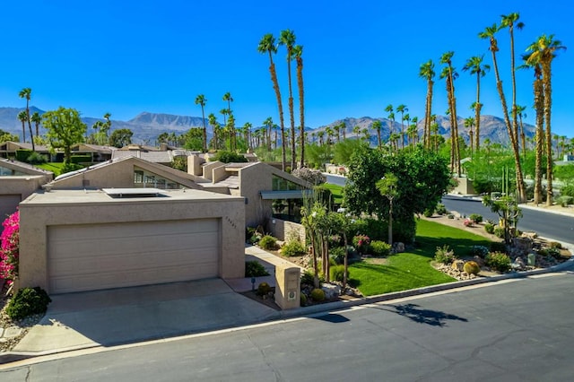 view of front of home with a garage and a mountain view