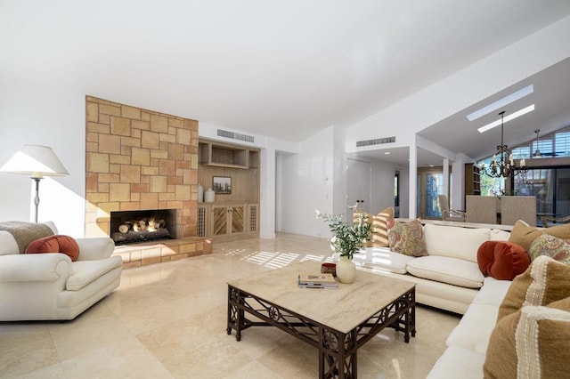 tiled living room featuring a stone fireplace, a notable chandelier, and vaulted ceiling