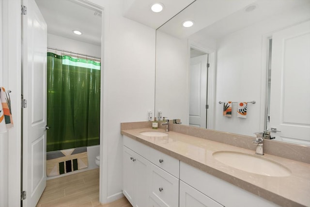 full bathroom with toilet, wood-type flooring, vanity, and shower / tub combo with curtain