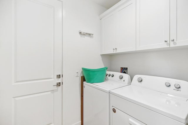 laundry room featuring cabinets and separate washer and dryer