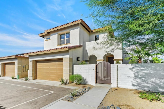 mediterranean / spanish-style house with a garage