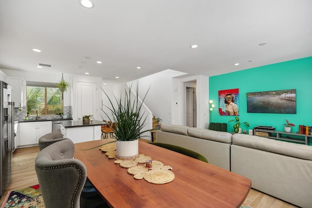 dining room featuring light hardwood / wood-style flooring and sink