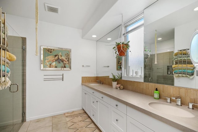 bathroom featuring vanity, tile patterned floors, and walk in shower