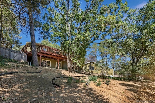 rear view of property featuring a wooden deck