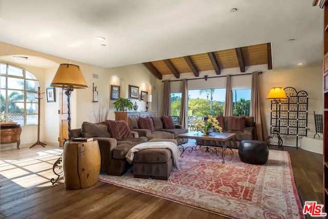 living room with hardwood / wood-style floors, vaulted ceiling with beams, wooden ceiling, and a wealth of natural light