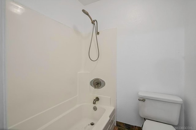 bathroom with toilet and washtub / shower combination