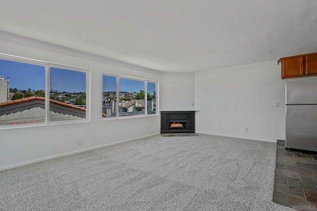 unfurnished living room with crown molding and dark colored carpet