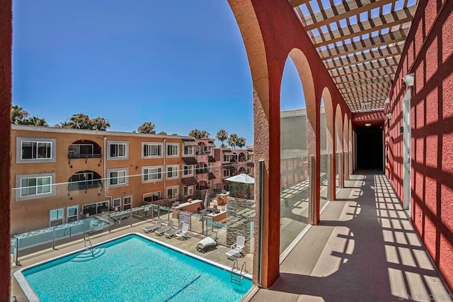 view of swimming pool featuring a pergola