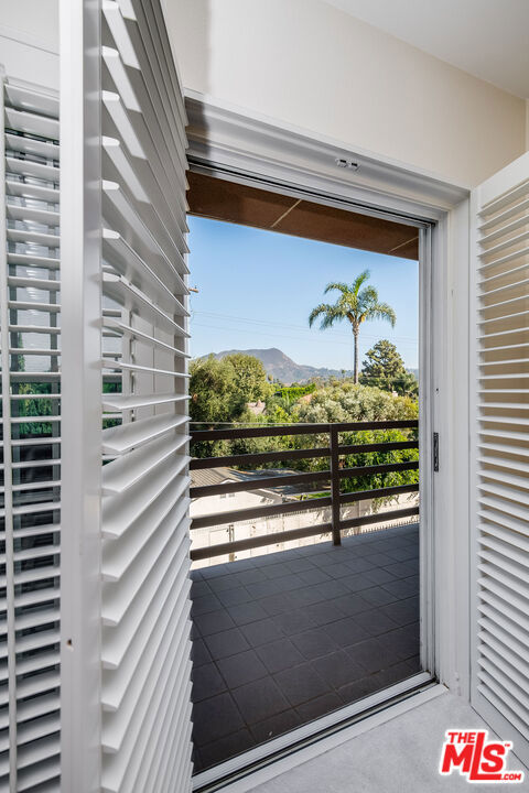 doorway with a mountain view and concrete flooring