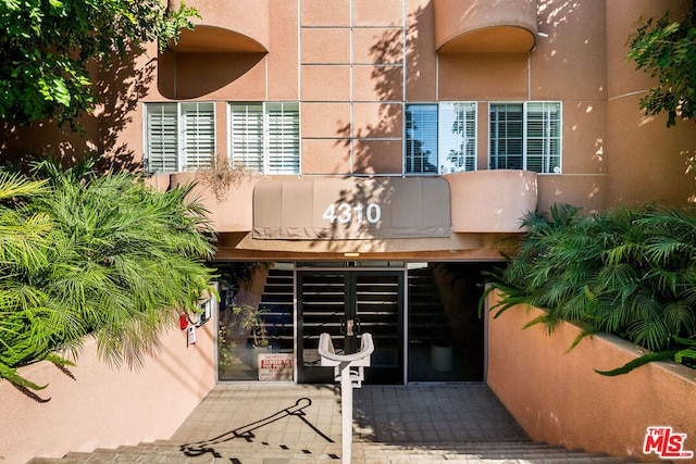 property entrance featuring a patio area