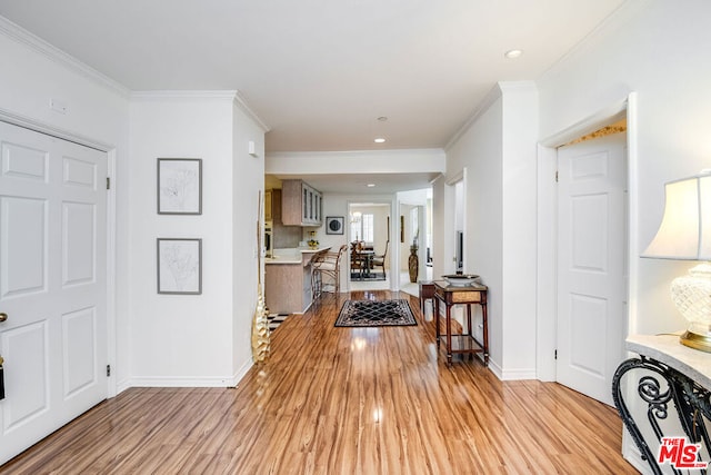 hall featuring ornamental molding and light wood-type flooring