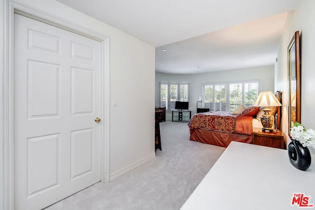 bedroom featuring light carpet