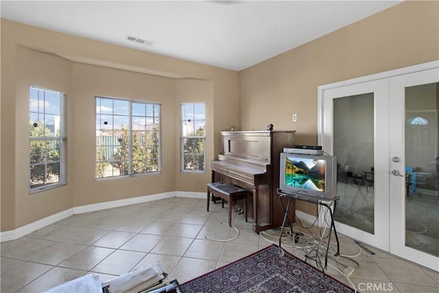 miscellaneous room featuring light tile patterned floors and french doors