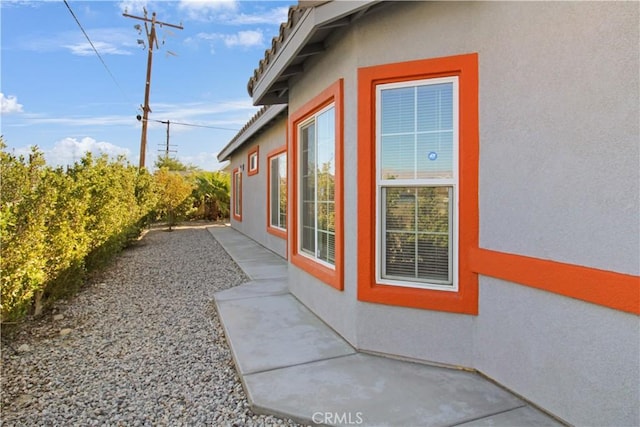 view of side of property with a patio