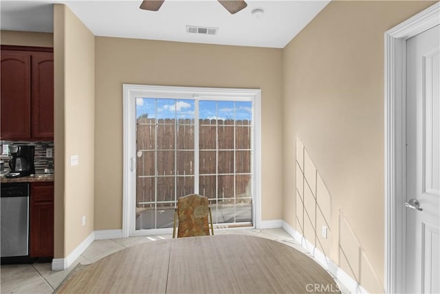 unfurnished dining area with ceiling fan and light tile patterned floors