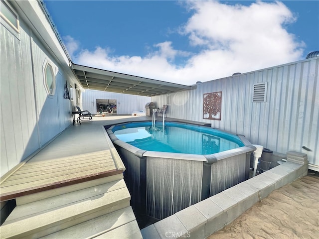 view of swimming pool with a wooden deck