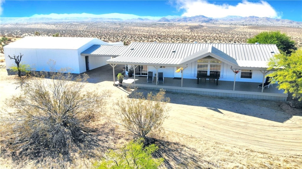 view of front of home featuring a patio, a mountain view, and metal roof