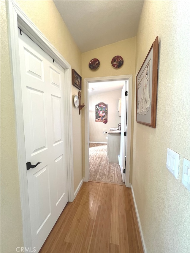 corridor featuring hardwood / wood-style floors