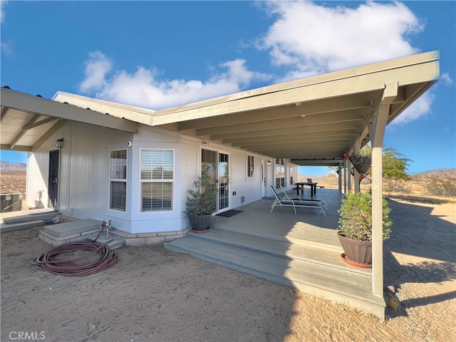 exterior space featuring a deck and cooling unit