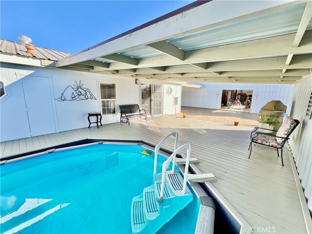 view of swimming pool with a deck and a fireplace