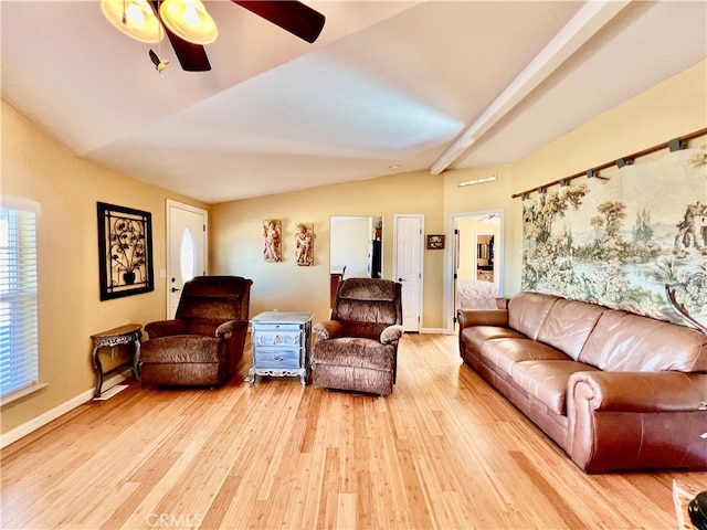 living room with hardwood / wood-style floors, ceiling fan, and vaulted ceiling