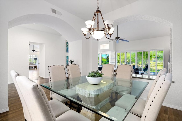 dining area with dark hardwood / wood-style floors and a notable chandelier