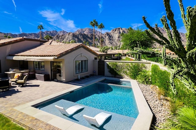 view of swimming pool featuring a mountain view, area for grilling, and a patio area