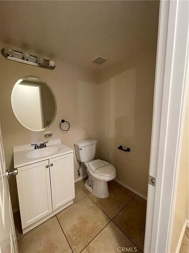 bathroom featuring tile patterned floors, vanity, and toilet