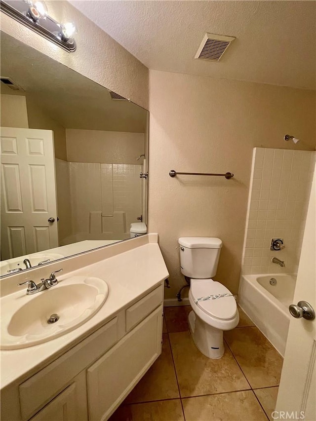 full bathroom featuring tile patterned floors, a textured ceiling, toilet, shower / tub combination, and vanity