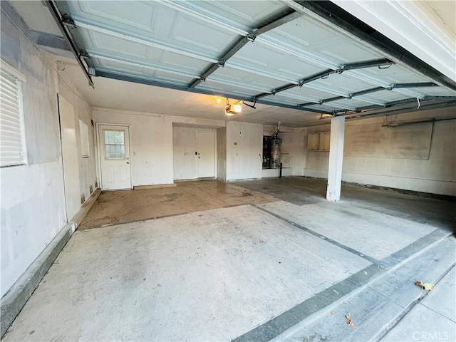 garage with strapped water heater and a garage door opener