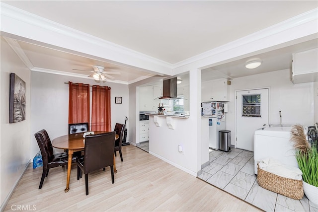 dining room featuring washer / dryer, crown molding, ceiling fan, and light hardwood / wood-style floors