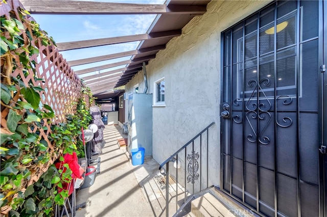 view of exterior entry with a pergola