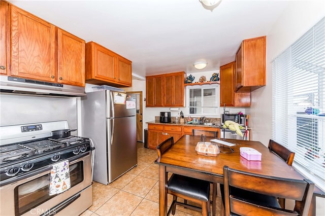 kitchen featuring sink, light tile patterned flooring, and stainless steel appliances