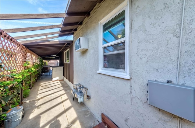 view of side of property featuring a wall unit AC