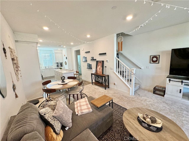 living room featuring light carpet and sink