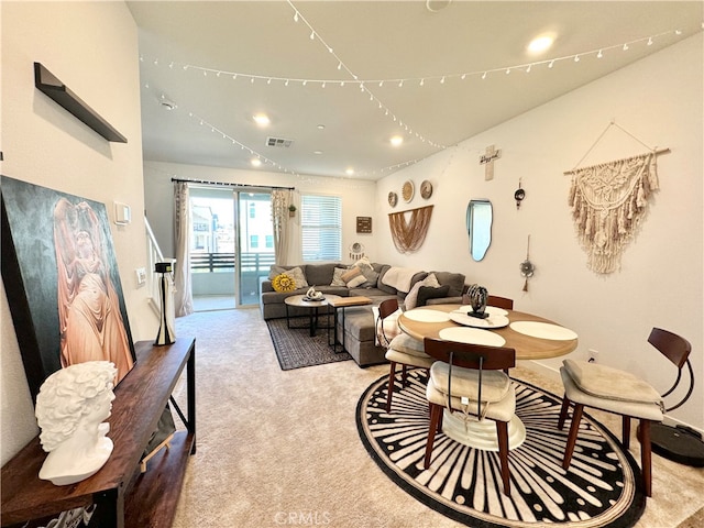 dining area featuring light carpet