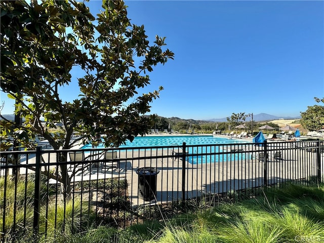 view of swimming pool with a mountain view