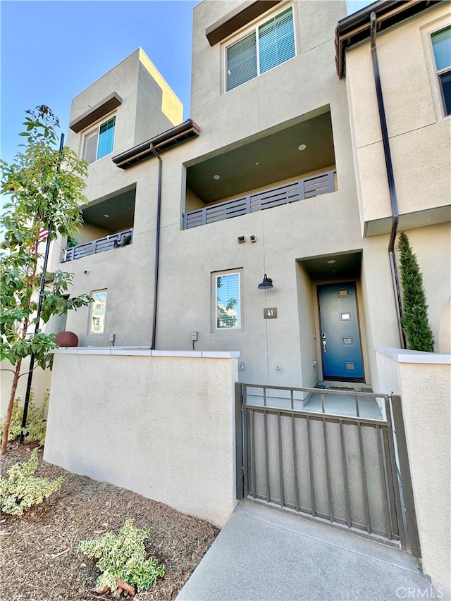 view of exterior entry with a balcony