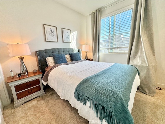 bedroom featuring light carpet