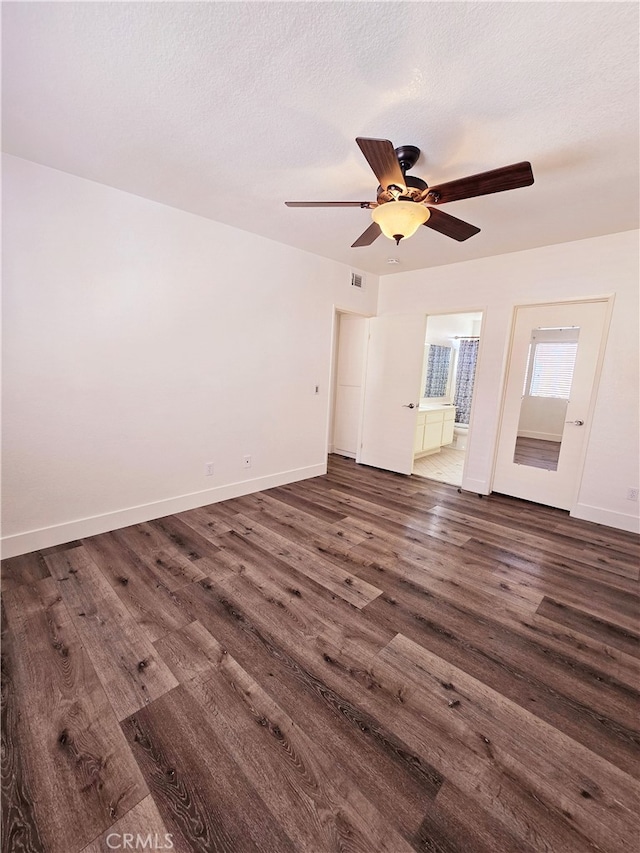 interior space featuring ceiling fan, a textured ceiling, and dark hardwood / wood-style floors