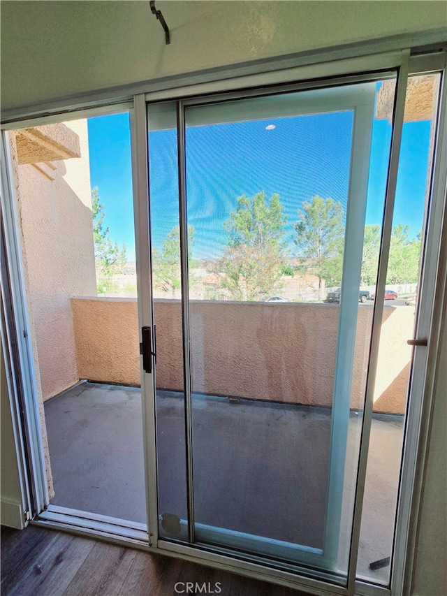 doorway to outside featuring plenty of natural light and hardwood / wood-style floors