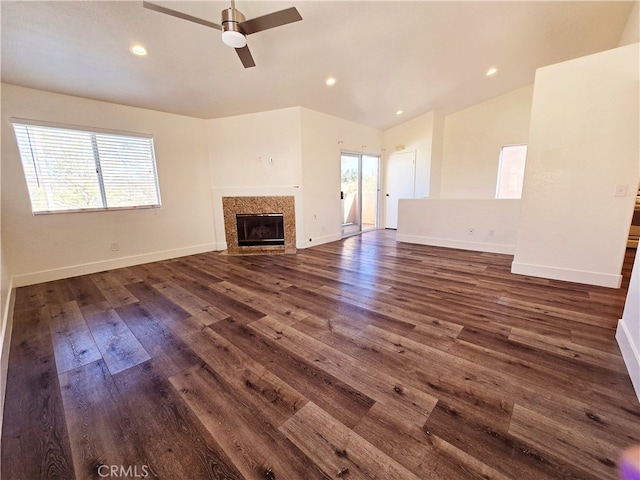 unfurnished living room featuring lofted ceiling, dark wood-type flooring, and ceiling fan