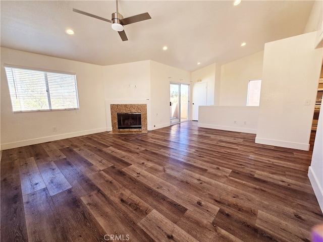 unfurnished living room with ceiling fan, vaulted ceiling, and dark hardwood / wood-style floors